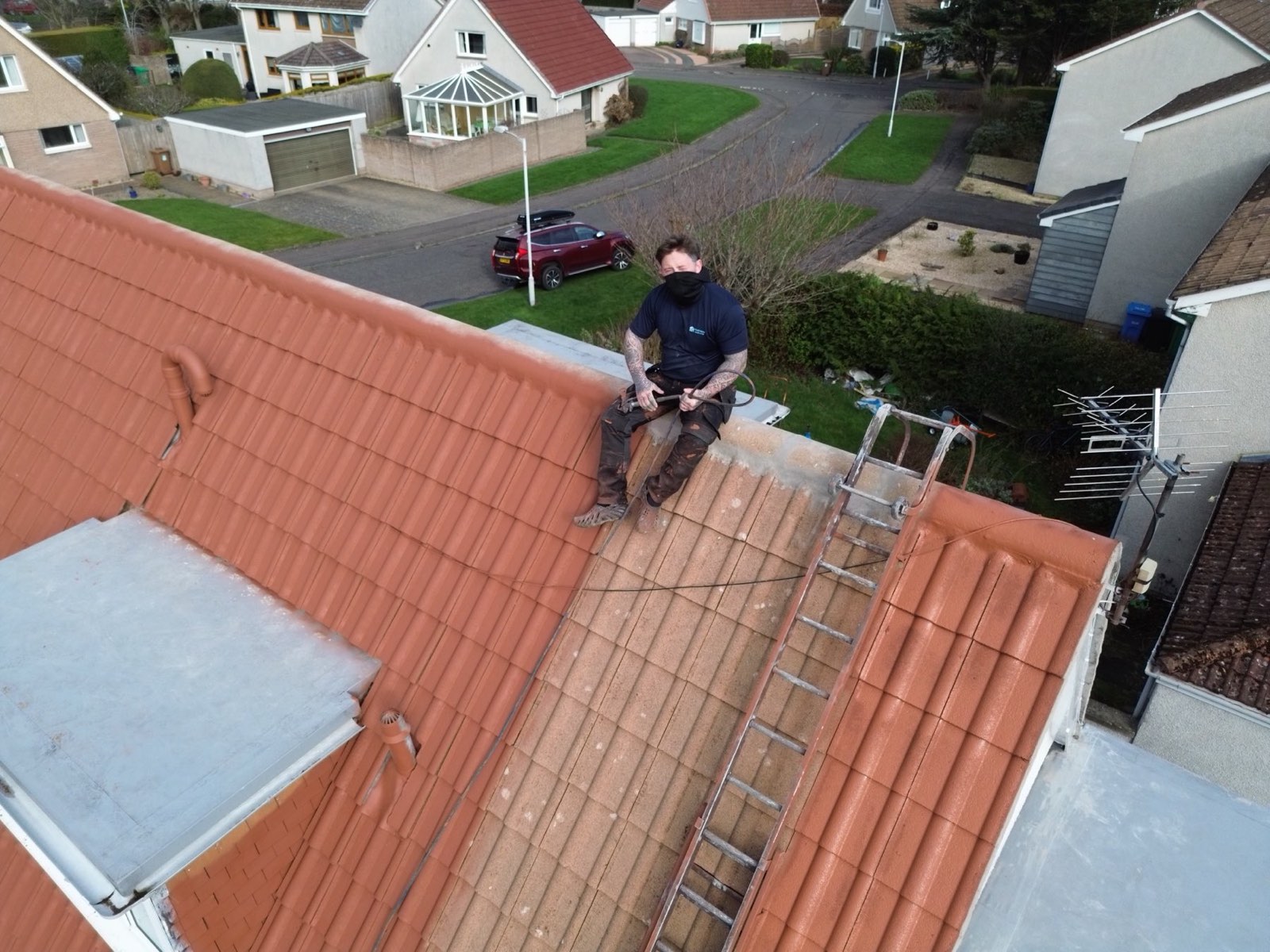 A WaveTech technician applying breathable hydrophobic coating across a roof