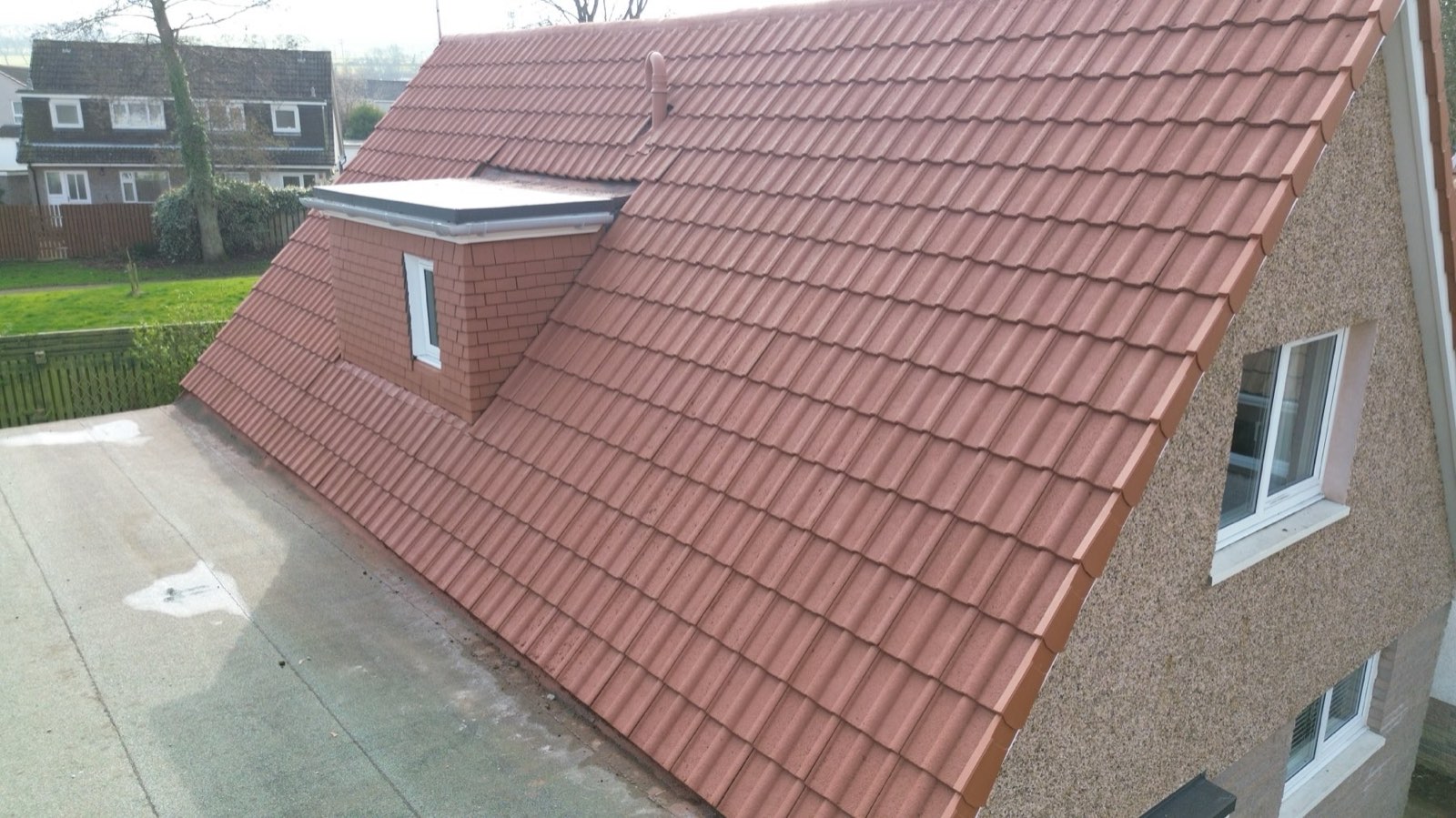 A cleaned and freshly coated roof showing the long-term result of combining services